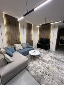 a living room with a couch and a table at محمد هوم in Al Hofuf
