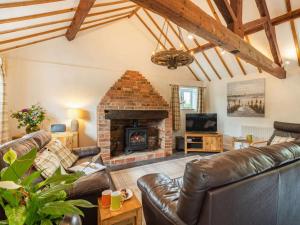 a living room with a couch and a fireplace at 3 Bed in Wareham oc-dc129 in Turners Puddle