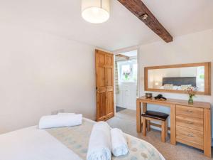 a bedroom with a bed and a desk and a mirror at 3 Bed in Wareham oc-dc129 in Turners Puddle