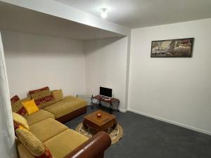 a living room with a couch and a table at Hotel Morez in Morez
