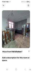 a kitchen with a counter and a refrigerator in a room at Appartement Le Cap in Cap Malheureux