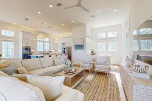 a living room with a white couch and a kitchen at Palmilla Beach Sunrise Dreams in Port Aransas
