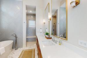 a white bathroom with two sinks and a tub at Palmilla Beach Sunrise Dreams in Port Aransas +19 photos