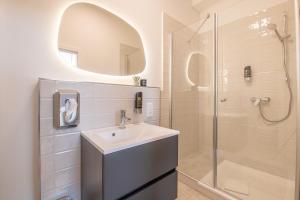 a bathroom with a sink and a shower at Altstadt City Loft in Würzburg +33 photos
