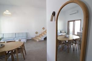 a room with a table and chairs and a mirror at Villa Yvon Telendos - Villa # 1 in Telendos +36 photos