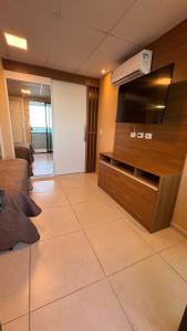 a living room with a flat screen tv on a wall at Jam flats beira mar Olinda in Olinda