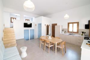 a kitchen and dining room with a table and chairs at Villa Yvon Telendos - Villa # 1 in Telendos