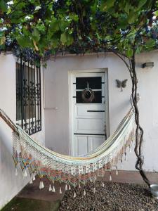 a porch with a hammock in front of a door at Como en casa in Concordia