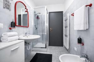 a white bathroom with a sink and a shower at Bella Vita Stays Cozy in Sondrio