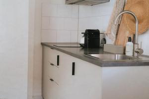 a kitchen with a sink and a counter top at West 7 in Zandvoort