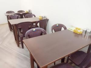 a row of tables and chairs in a room at Hotel Sanskar in Pachmarhī +5 photos