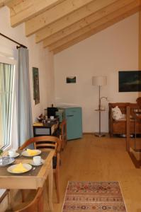 a living room with a wooden table and chairs at Chesa Clavazzin in Brunnadern