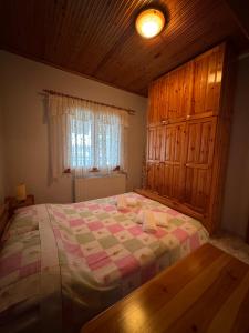 a bedroom with a large bed with a wooden ceiling at Pansedon House by the sea in Nea Kallikrateia +15 photos