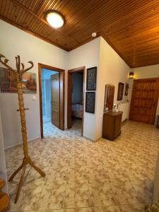 a large room with a wooden ceiling and a room with a table at Pansedon House by the sea in Nea Kallikrateia