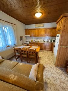 a kitchen with a table and a dining room at Pansedon House by the sea in Nea Kallikrateia