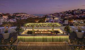 a rooftop garden with a pergola with lights at Tivoli Avenida Liberdade Lisboa – A Leading Hotel of the World in Lisbon