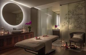 a bathroom with a bed and a sink and a mirror at Tivoli Avenida Liberdade Lisboa – A Leading Hotel of the World in Lisbon