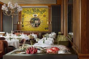 a dining room with a table with food on it at Tivoli Avenida Liberdade Lisboa – A Leading Hotel of the World in Lisbon