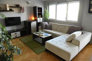 a living room with a couch and a tv at Mustache 3 Room Apt City Center in Bitola