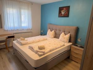 a bedroom with a bed with a blue wall at Apartments Amela in Pula +227 photos