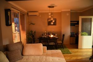 a living room with a couch and a dining room table at Mustache 3 Room Apt City Center in Bitola