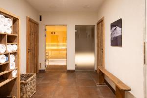 a hallway with a bench and a door to a room at Hotel & Spa Merilys in Méribel +79 photos