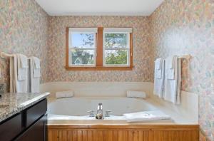 a bathroom with a tub and a window at The Ocracoke Harbor Inn in Ocracoke +79 photos
