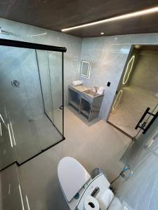 a bathroom with a shower and a toilet and a sink at HOTEL NOVO CENTRO in Petrolina +81 photos
