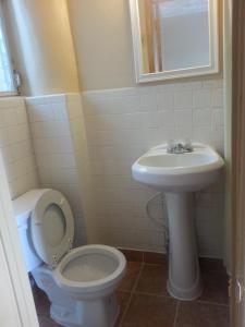 a bathroom with a toilet and a sink at Atlantic Inn Seaside Heights in Seaside Heights +11 photos