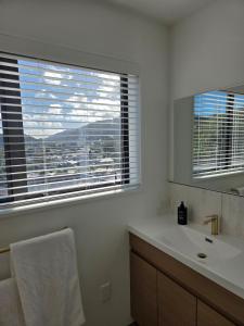 a bathroom with a sink and a window with a view at The Landing - Picton in Picton