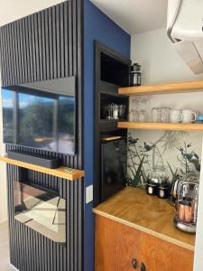 a kitchen with a black and white counter and a kitchen at The Landing - Picton in Picton