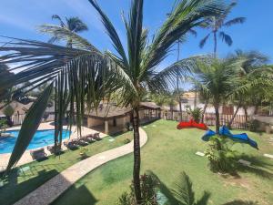 an aerial view of a resort with a pool and palm trees at Cumbuco Residence #203 in Caucaia