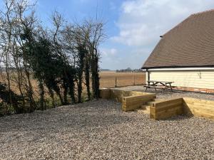 a picnic table and a bench next to a building at Tollgate Annexe in Ashford
