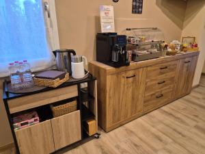 a coffee shop with a counter with a coffee maker at Hibiscus Affittacamere - rooms&more in Stanghella +13 photos