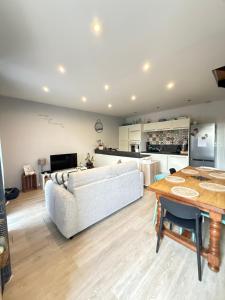 a living room with a couch and a table at Charmant appartement à Roanne in Roanne