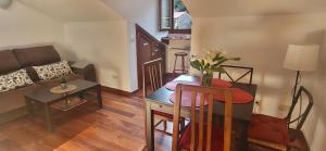 a living room with a table and a couch at Ca Na Daniela in Carreña de Cabrales +21 photos
