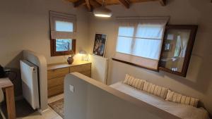 a small bedroom with a bed and a window at Iriti's Villa & Dahlia Studio in Platanidia