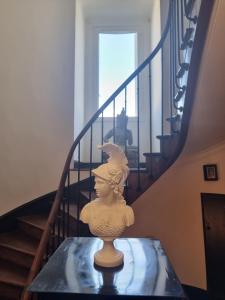 a vase sitting on a glass table next to a staircase at App T2 avec piscine chauffée in Luchon