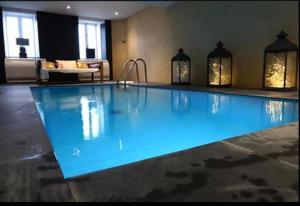 a large swimming pool in a hotel room at App T2 avec piscine chauffée in Luchon