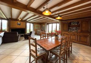 a dining room with a wooden table and chairs at L'espiatet in Borce