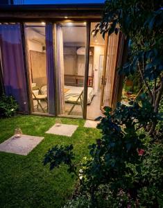 a glass house with a view of a room at Beus home in Durrës +2 photos