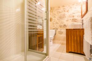 a bathroom with a shower and a toilet at La Sérénité in Najac +32 photos