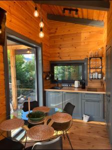 a kitchen with a table and chairs in a cabin at Paul Lake Escape Residence in Novosëlki
