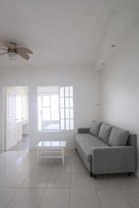 a living room with a couch and a table at STAYLUXIA MANILABAYVIEW - FEATURING 1 - 5 BEDROOM SUITES WITH BALCONY POOL BAYVIEWS NETFLIX - Housekeeping Available- in Manila +63 photos