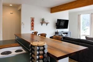 a living room with a table and a couch at Lake Sutherland Retreat in Port Angeles