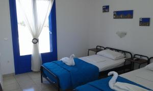 a bedroom with two beds and a window at Vigles in Adamantas