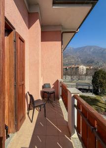 a balcony with a table and chairs and a view at Fell Hotel in Susa