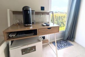 a kitchen with a counter with a microwave and a window at Chambre d'hôtes - B&B - Le Cocon de Manon en Luberon in Lagnes