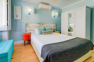 a bedroom with a large bed and blue walls at Casas da Baixa - Jules & Madeleine in Lisbon