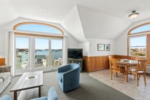 a living room with a couch and a table at The Ocracoke Harbor Inn in Ocracoke